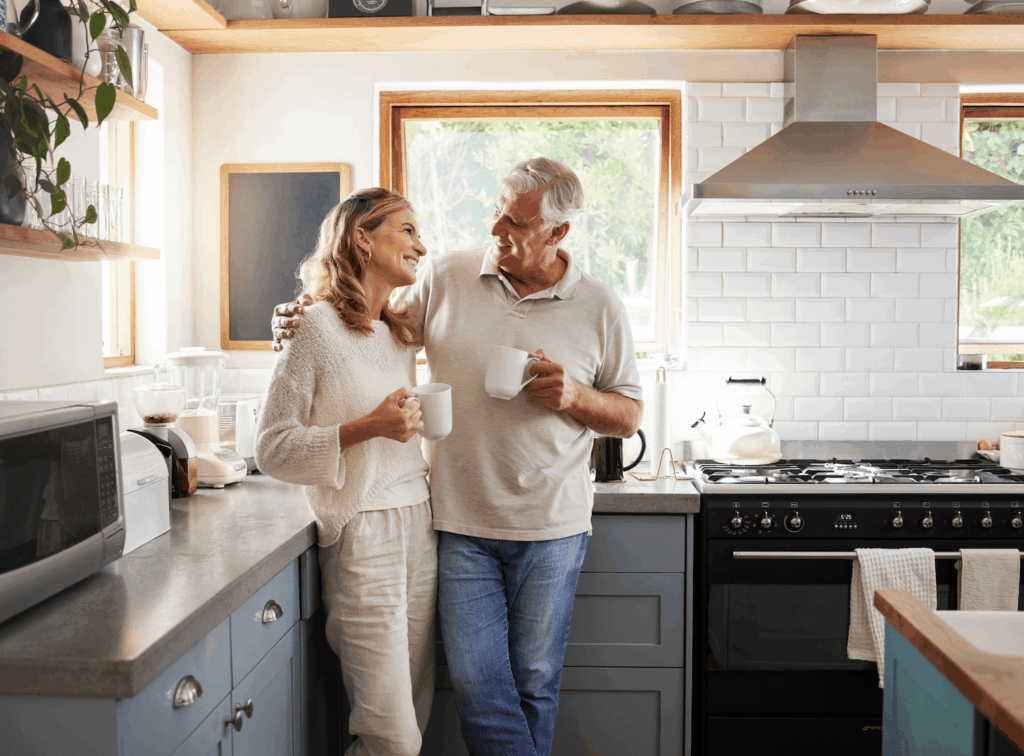 elderly couple chatting in a kitchen