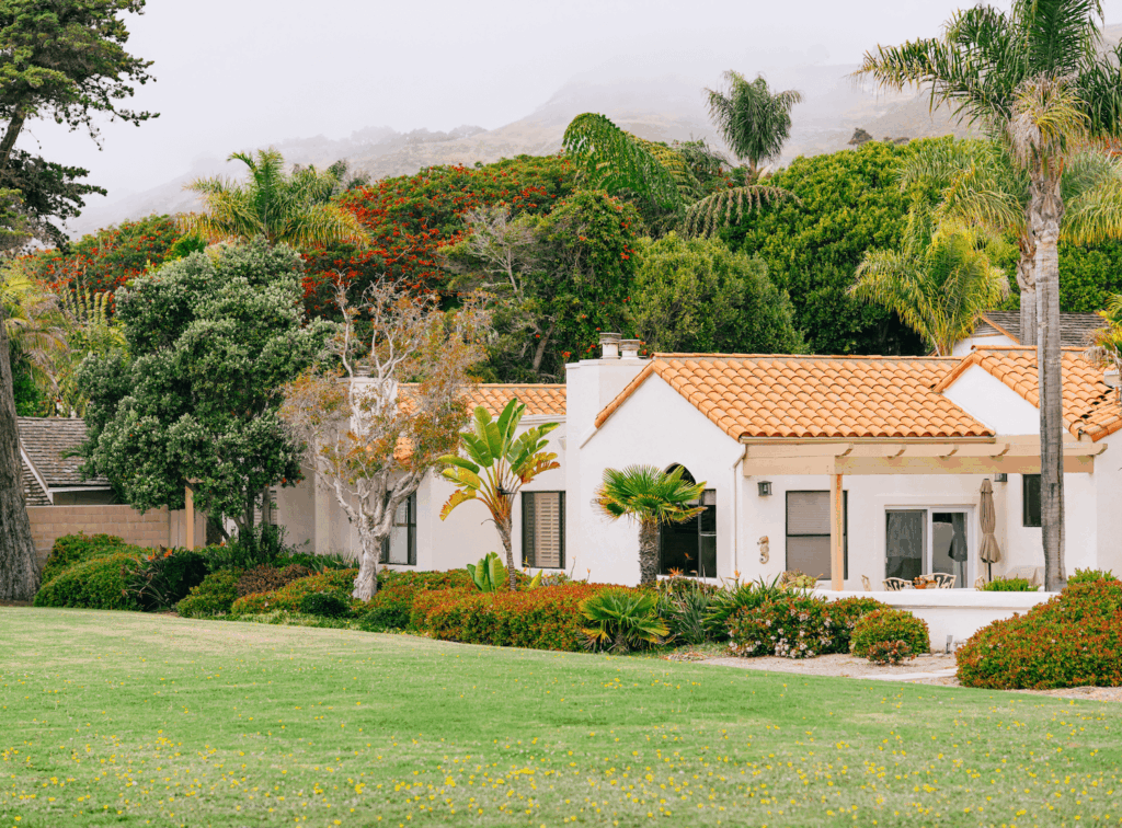 White house with orange rooftop with lawn